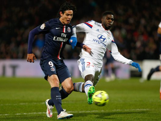 FILE - In this Sunday Feb. 8, 2015 file photo, Paris Saint Germain's Uruguayan forward Edinson Cavani, left, challenges for the ball with Lyon's French defender Samuel Umtiti, during the League One soccer match between Lyon and Paris Saint-Germain, at the Gerland Stadium, in Lyon, central France. Many nations are betting on youth at the European Championship, giving promising youngsters a chance to breakthrough in France. Some of the top nations have included up-and-coming players in their squads for this months tournament, with some giving up experience to make way for young talent. (AP Photo/Claude Paris, File)
